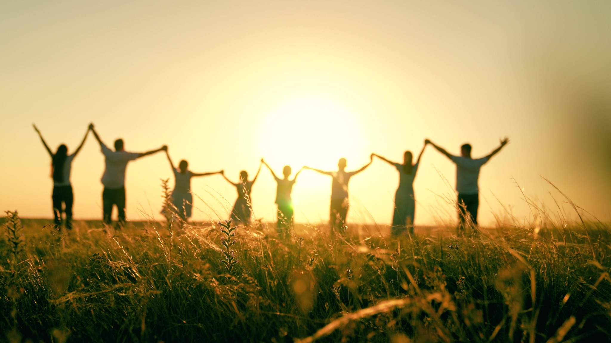 Group of teenagers together outdoors at sunset