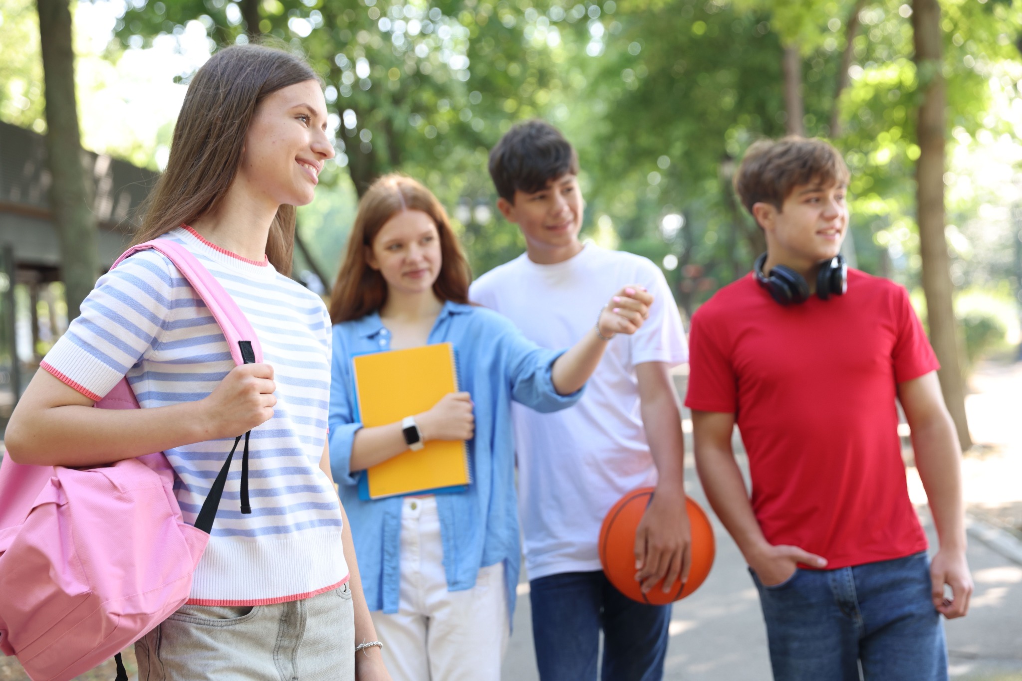 Teenagers together outdoors in a school-like setting